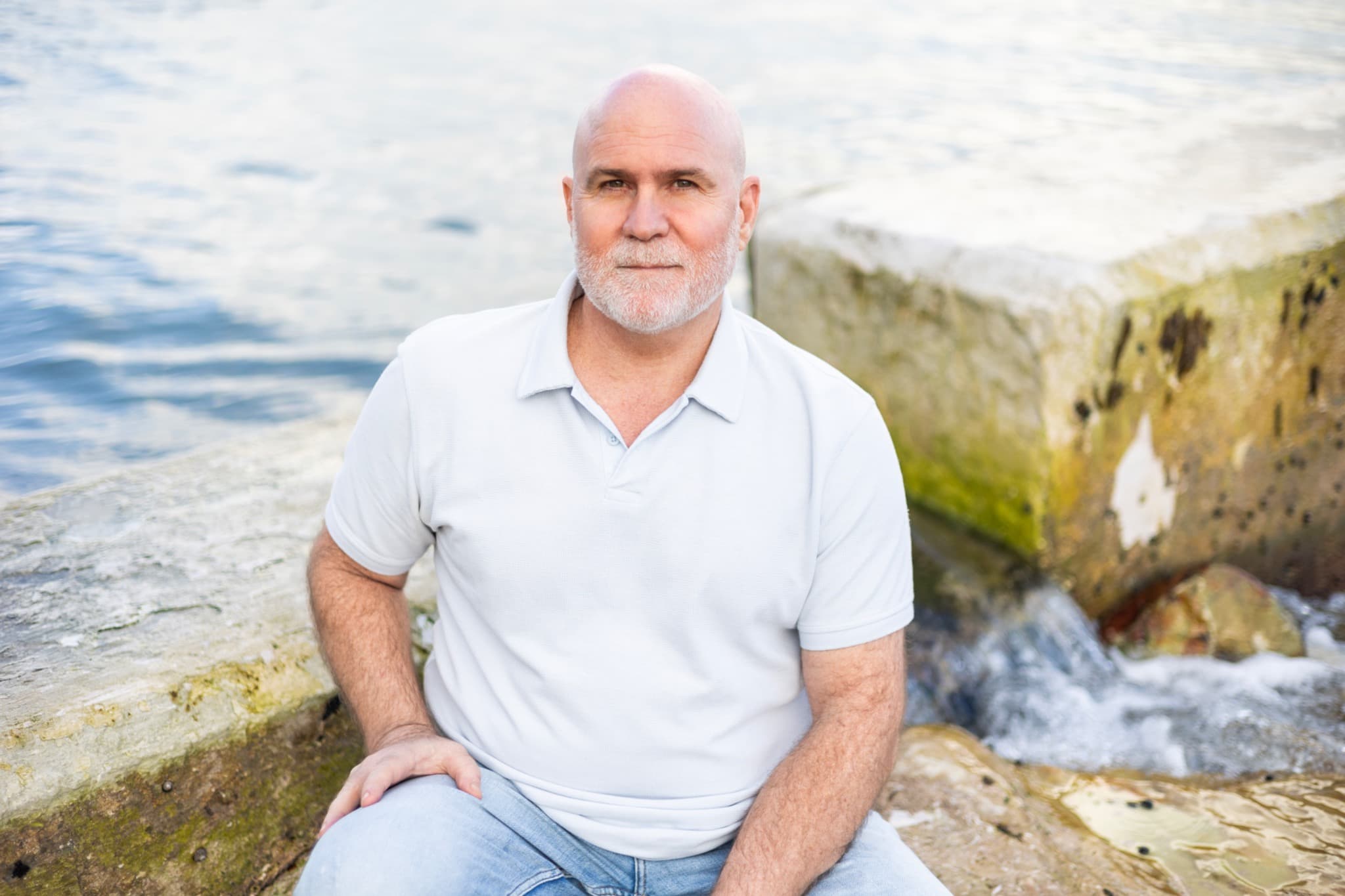 Andrew Barnes seated beside the water
